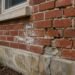 Damaged brick wall showing cracks